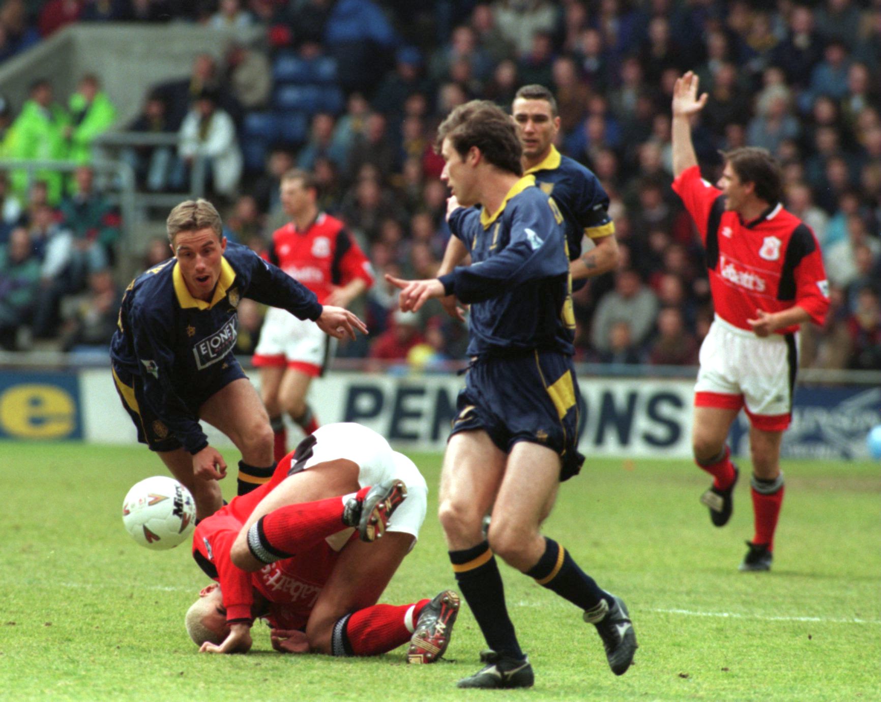 13 MAY 1995:  STAN COLLYMORE OF NOTTINGHAM FOREST GOES DOWN AFTER A CHALLENGE FROM CHRIS PERRY OF WIMBLEDON DURING THE WIMBLEDON V NOTTINGHAM FORES...