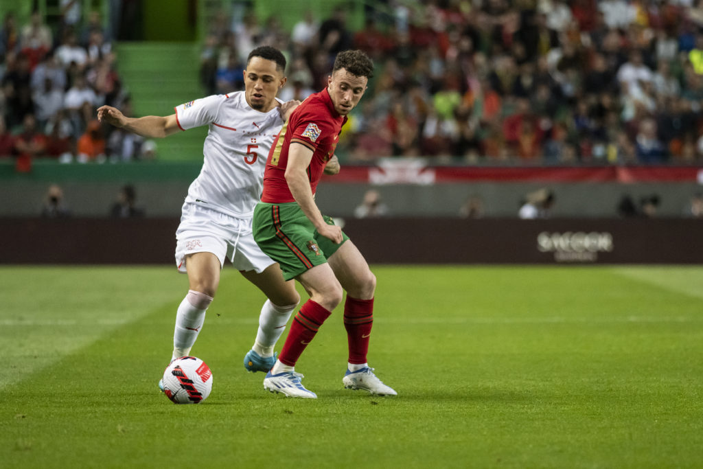 Noah Okafor (L) of Switzerland and Diogo Jota (R) of