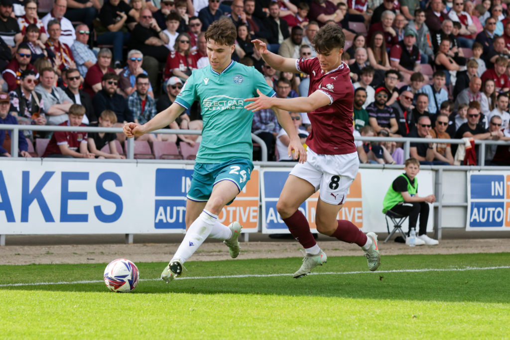 Tyler Bindon is challenged by Ben Perry during the first half of the Sky Bet League 1 match between Northampton Town and Reading