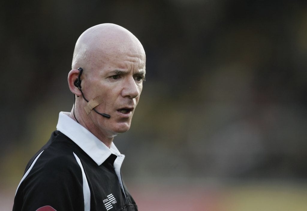 Dermot Gallagher working as a referee 
