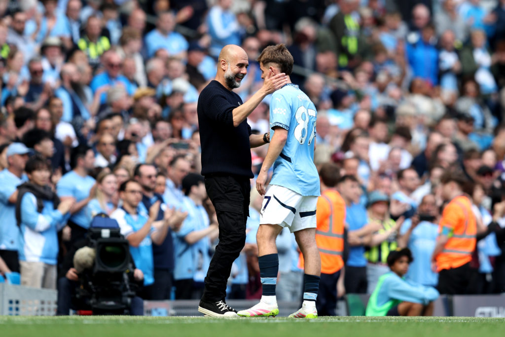 Pep Guardiola embraces James McAtee during game against Crystal Palace at the Etihad